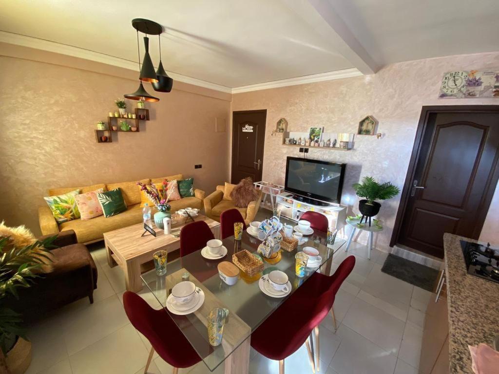 a living room with a table and red chairs at NB Marrakech in Marrakesh