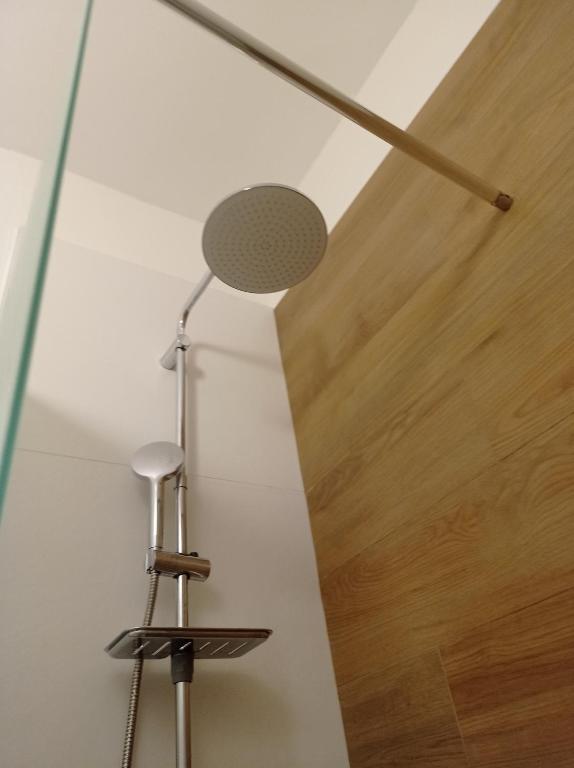 a lamp in a room with a wooden ceiling at CasaRA in Bari