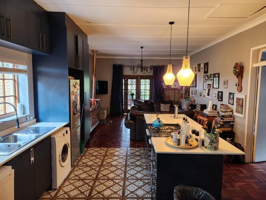 a kitchen and a living room with a kitchen and a living room at Melvilla House in Johannesburg