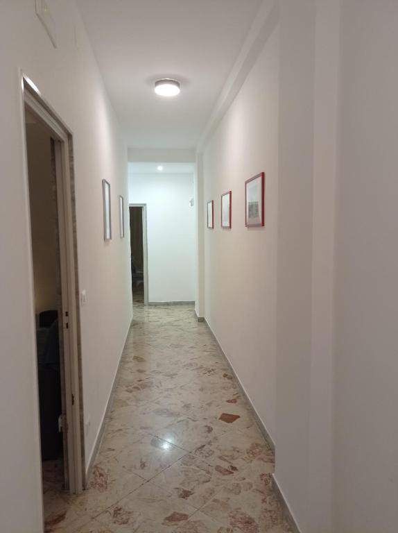 a hallway with white walls and a tile floor at CasaRA in Bari