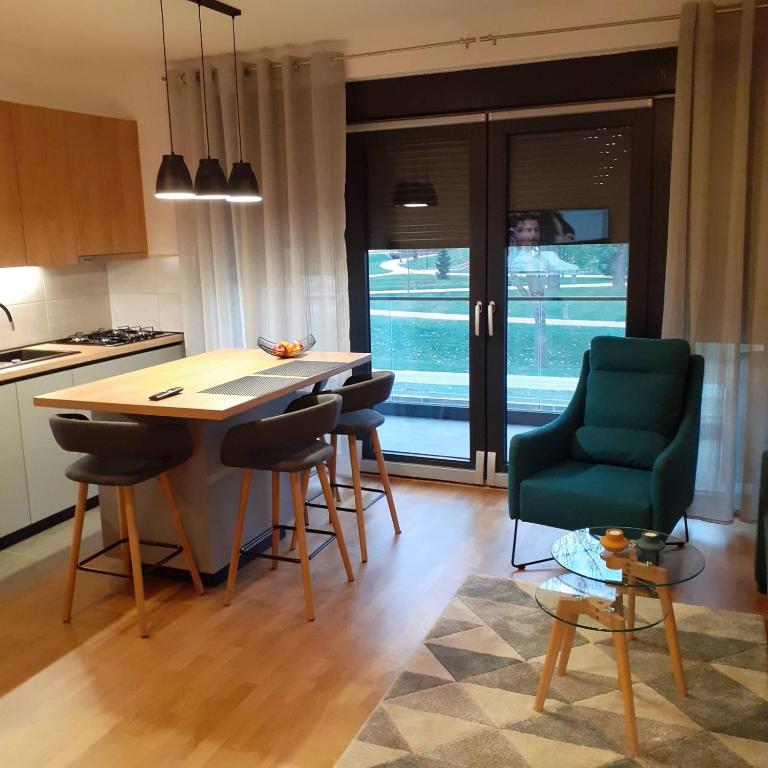 a kitchen with a table and chairs in a room at Mabela in Virovitica