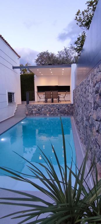 a swimming pool in front of a house at Villa Porto - Βίλα με ιδιωτική πισίνα in Porto Rafti