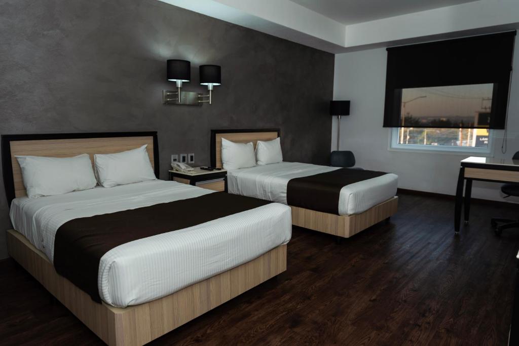 Postel nebo postele na pokoji v ubytování Fato Hotel