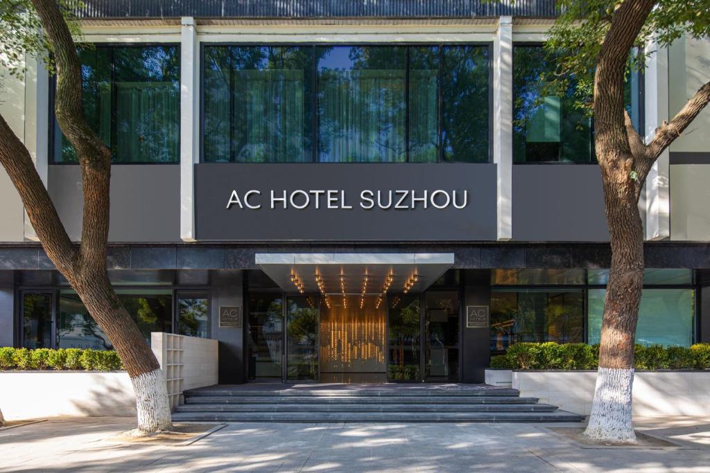 AC Hotel by Marriott Suzhou China في سوتشو: مبنى مع علامة تنص على مترو ac hotel sukhumvit