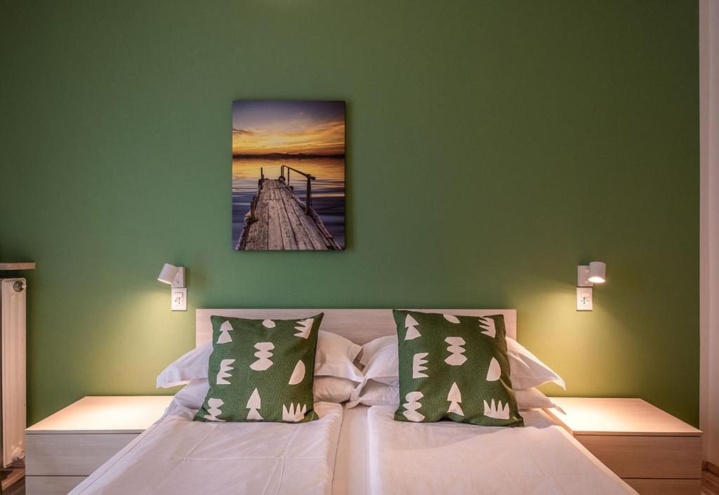 a bedroom with a bed with a painting on the wall at Lake view with Aircon - 5 minutes from the beach! in Brenzone sul Garda