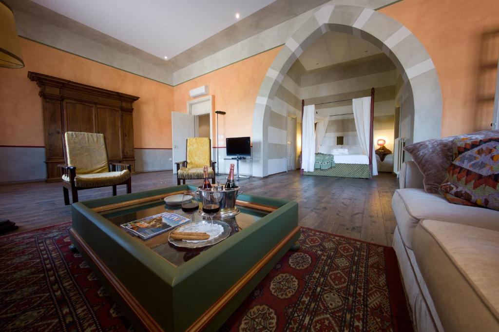 a living room with a couch and a table at Palazzo Castiglioni Luxury Suites in Mantova