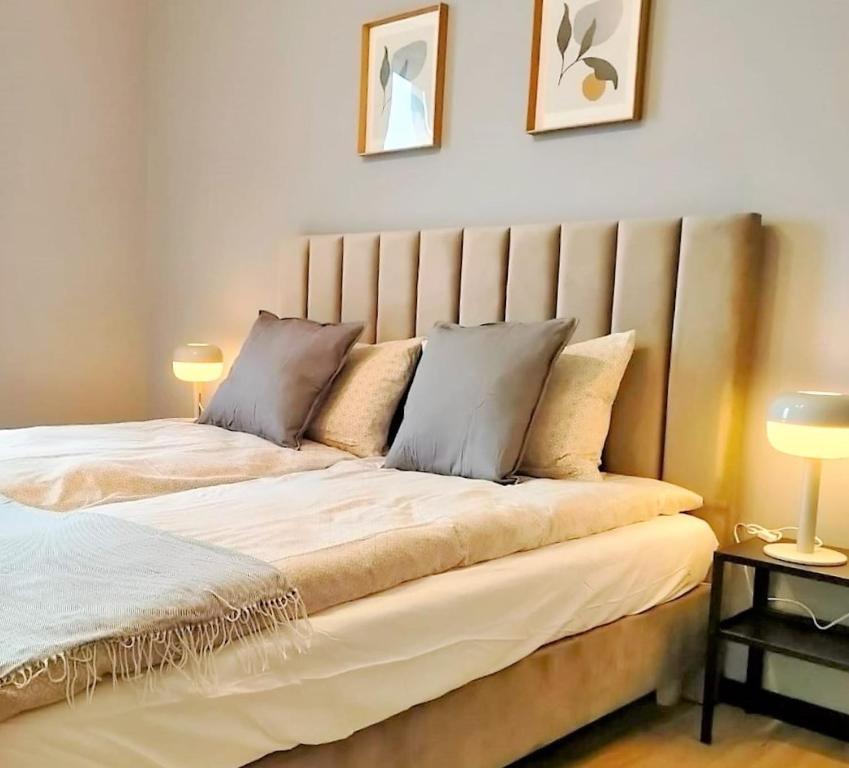 a bedroom with a large bed with two pillows on it at SECOND HOME Lubawa in Lubawa