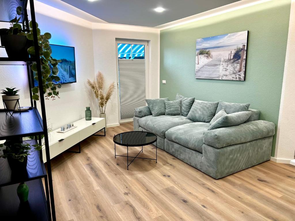 a living room with a couch and a table at Apartment Klabautermann in Neubukow