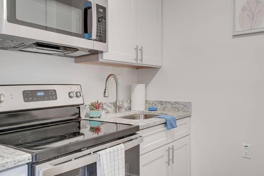 a kitchen with a sink and a stove top oven at Newly Renovated 1 Bedroom Apartment near Downtown in Gadsden