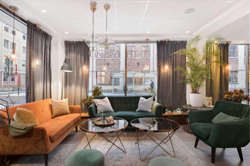 a living room with a couch and chairs at Best Western Plaza Hotel in Eskilstuna