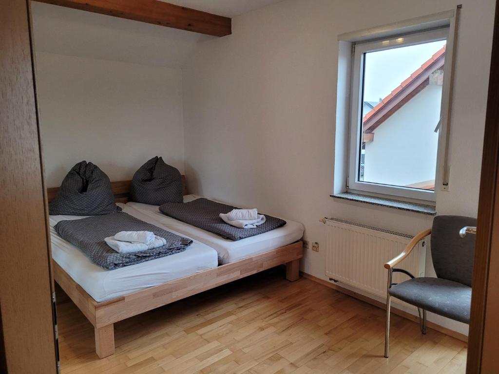 a small bedroom with a bed and a window at Ferienhaus Vongerichten in Oberhausen