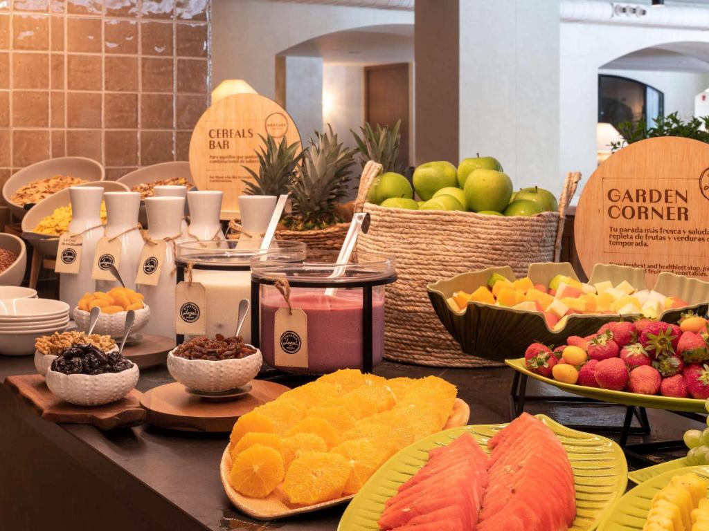 a buffet of fruit and other food on a table at Mercure Benidorm in Benidorm