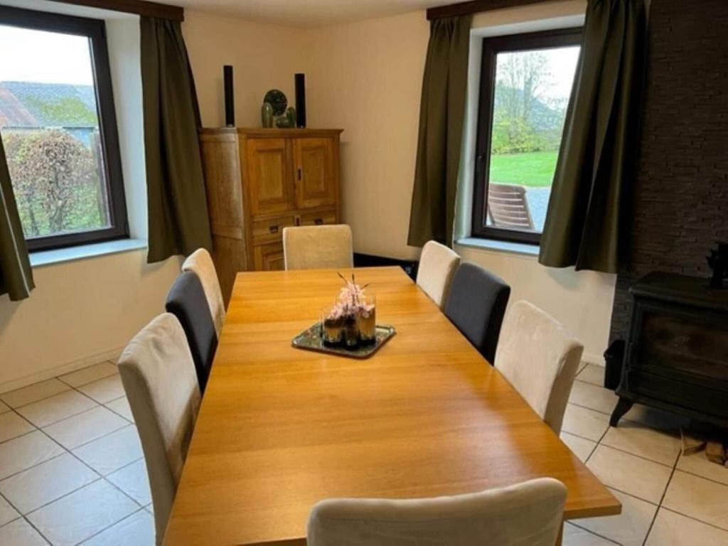 a dining room with a wooden table and chairs at Lovely holiday home in Gouvy with sauna in Gouvy