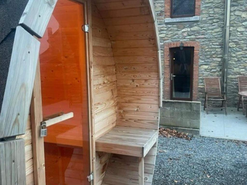 an outside sauna with a bench in a building at Lovely holiday home in Gouvy with sauna in Gouvy