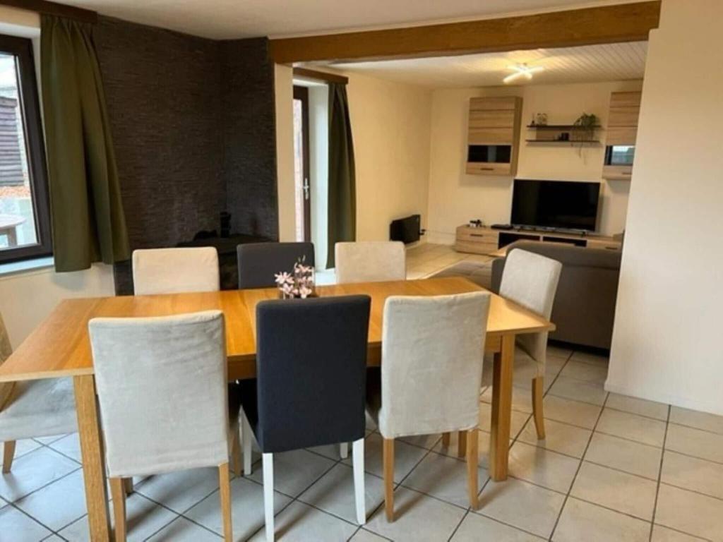 a dining room with a wooden table and chairs at Lovely holiday home in Gouvy with sauna in Gouvy