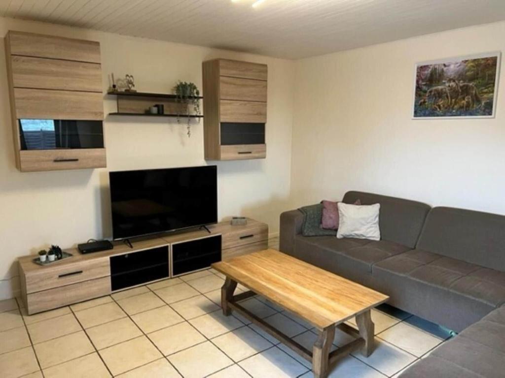 a living room with a couch and a table at Lovely holiday home in Gouvy with sauna in Gouvy