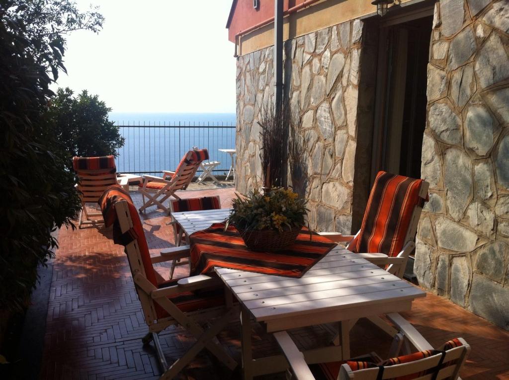 Una mesa y sillas de madera en un patio. en La Rosa dei Venti, en Bergeggi
