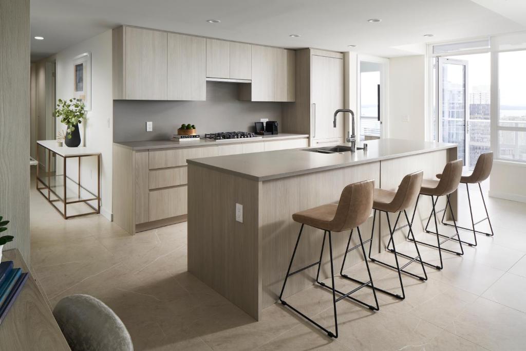 a kitchen with a island with bar stools at Level Seattle Downtown - South Lake Union in Seattle