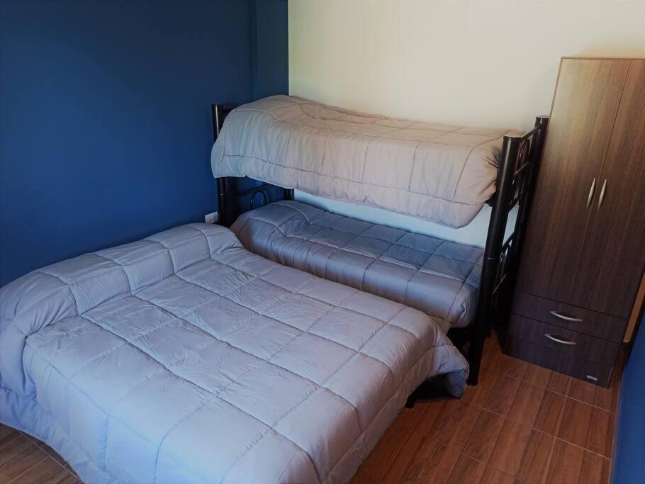Llit o llits en una habitació de Dpto Senderos de Andorra - USHUAIA