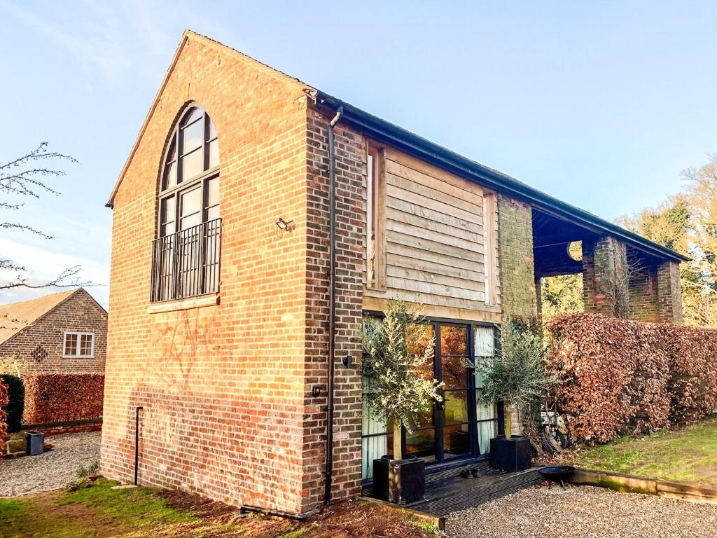 a brick building with a large window on it at Olive in Kelsall