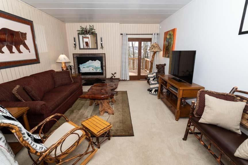 a living room with a couch and a piano at Cozy Seven Springs 1 Bedroom Condo with Private Deck condo in Champion