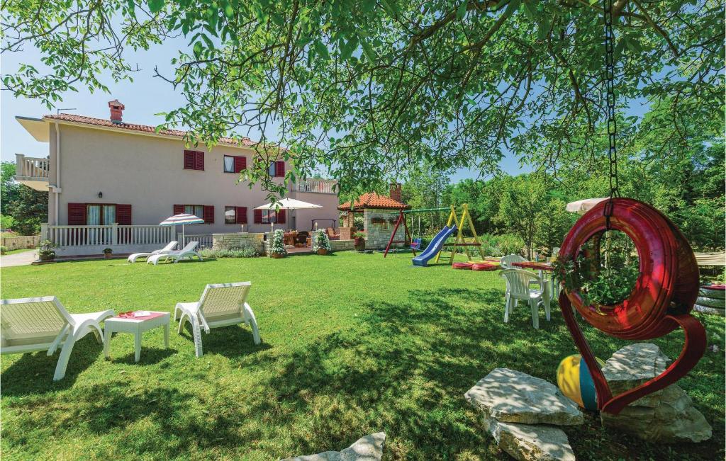 a yard with a playground and a house at Nice Apartment In Nedescina With Wifi in Nedeščina