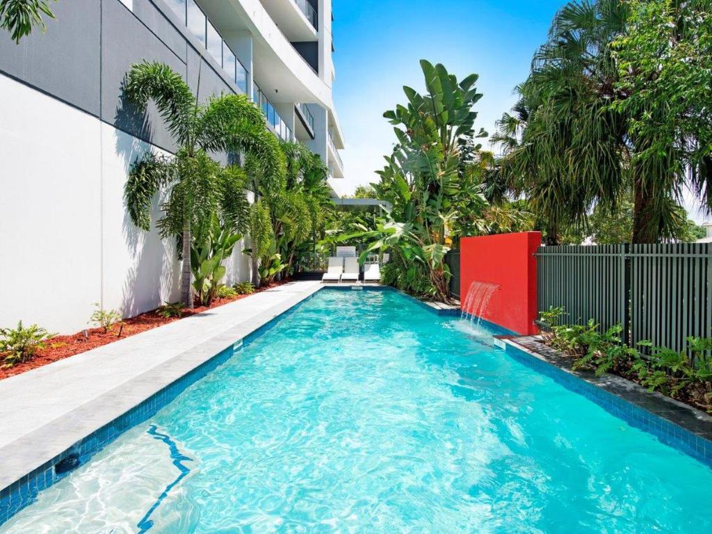 a swimming pool in front of a building at Harbour Quays Apartments in Gold Coast