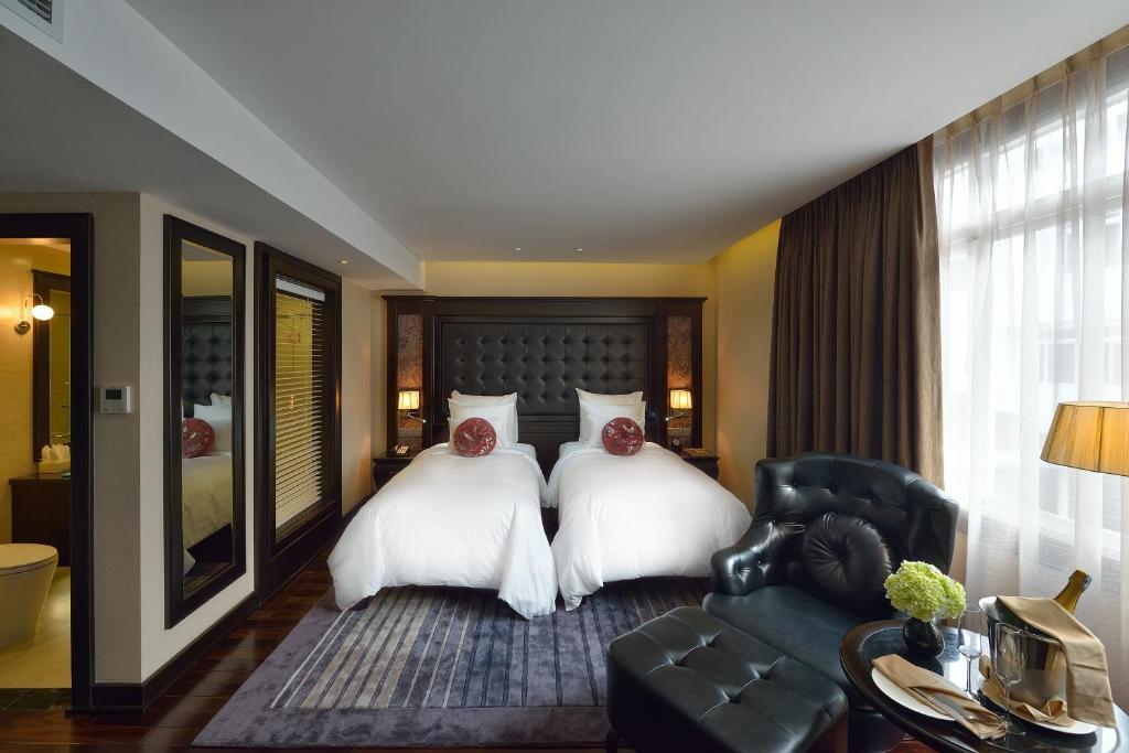 Postel nebo postele na pokoji v ubytování Paradise Suites Hotel