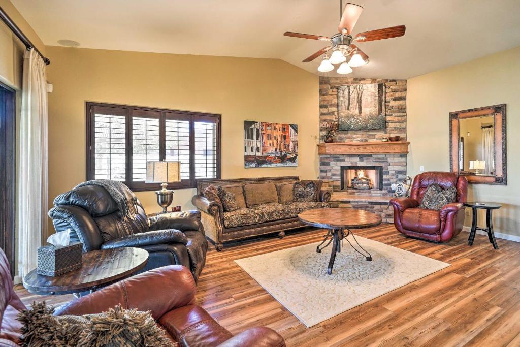 a living room with leather furniture and a fireplace at Lake Havasu City Vacation Rental with Pool! in Lake Havasu City