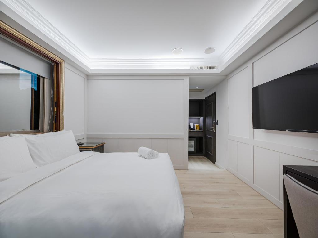Postel nebo postele na pokoji v ubytování Archess Hotel