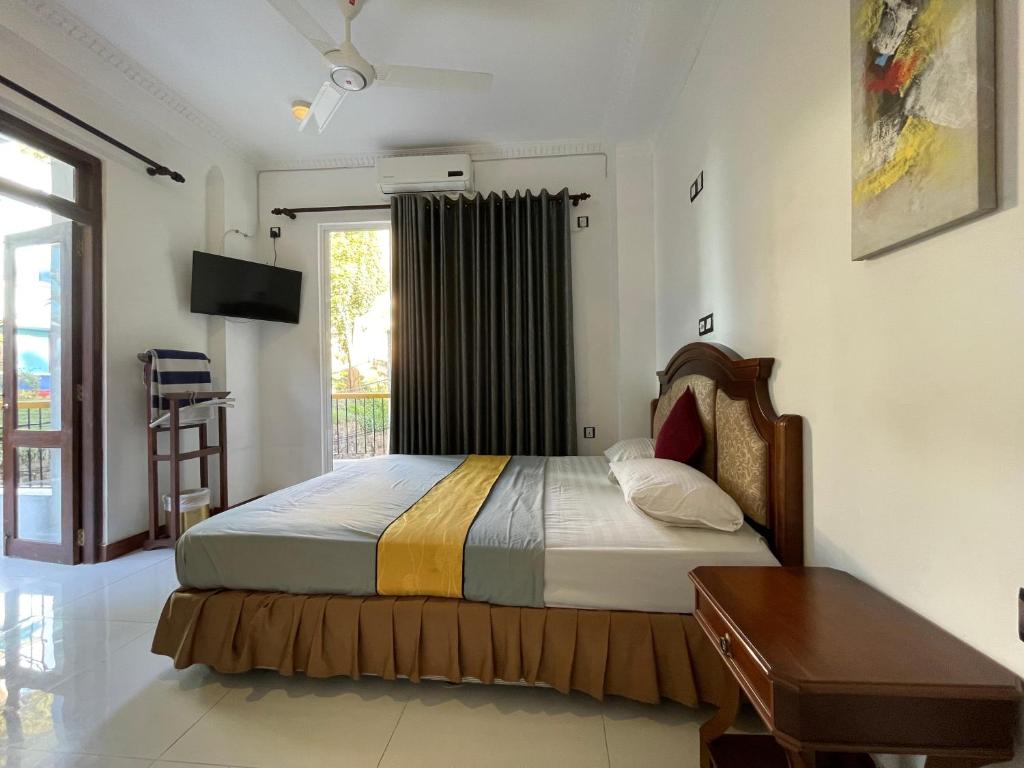 a bedroom with a bed and a large window at Eagle's Residence in Kandy