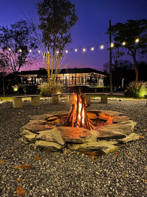 a fire pit in a park at night at The Wild Khao Yai in Klang Dong