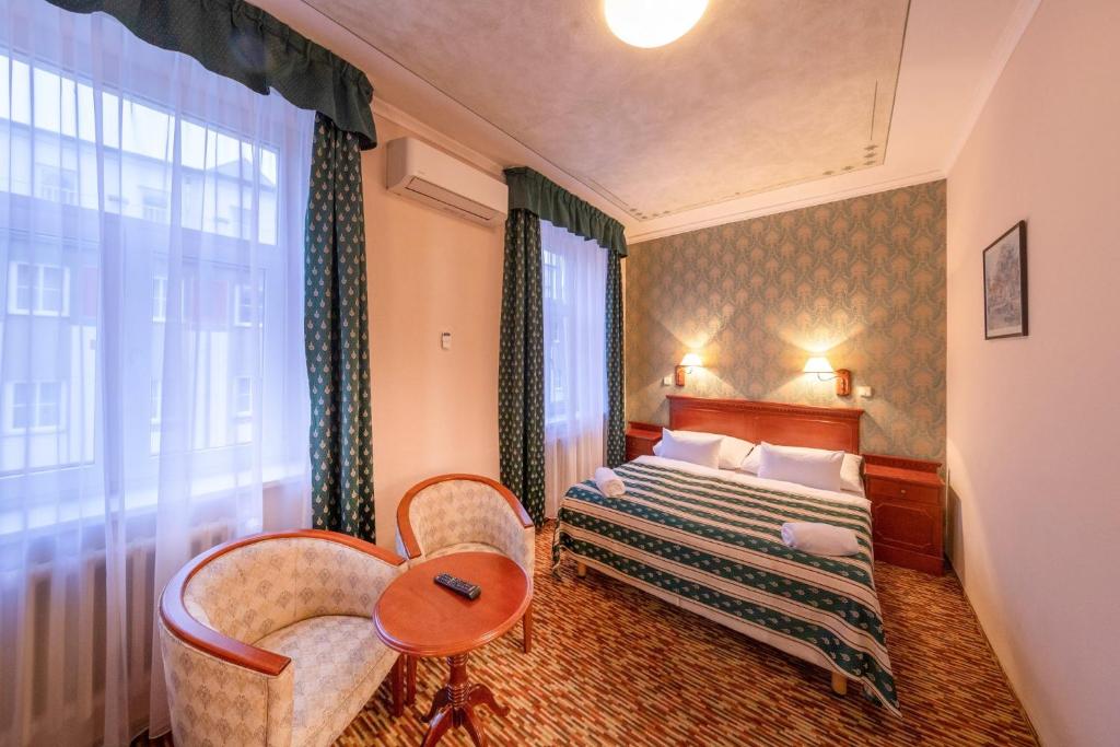 a hotel room with a bed and a window at Hotel Meteor Plaza Prague in Prague