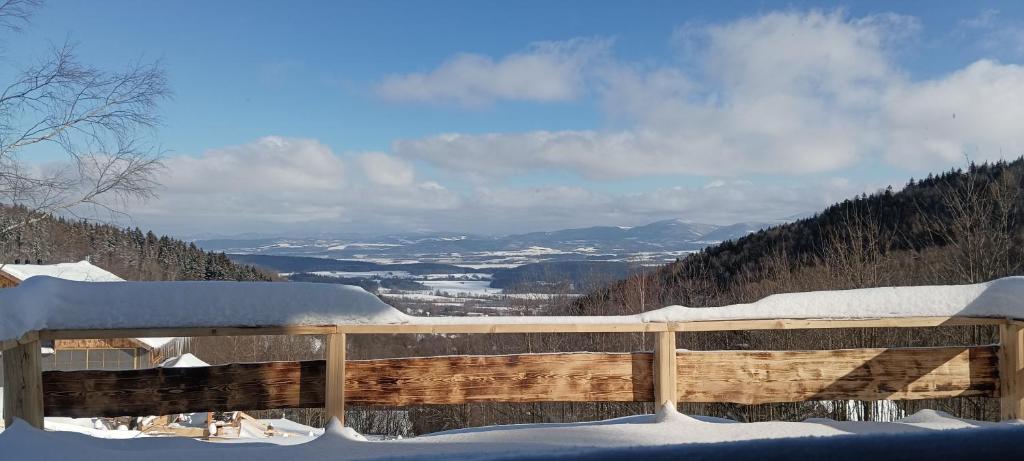 a snow covered deck with a view of a valley at Enklawa w Porębie in Długopole-Zdrój