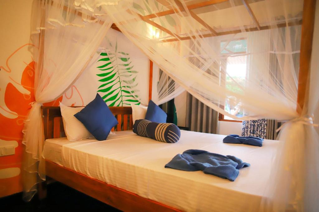 Postel nebo postele na pokoji v ubytování Ruwan Jungle Homestay