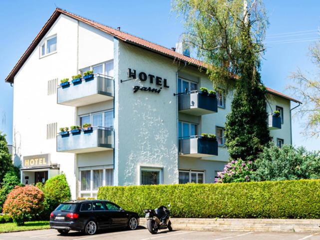 un edificio de hotel con un coche aparcado delante de él en Hotel Garni en Metzingen