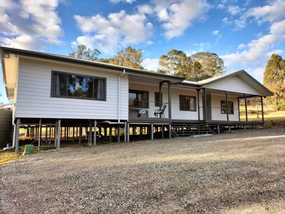 a large white house with a lot of windows at Lambs Valley Guest House. in Lambs Valley