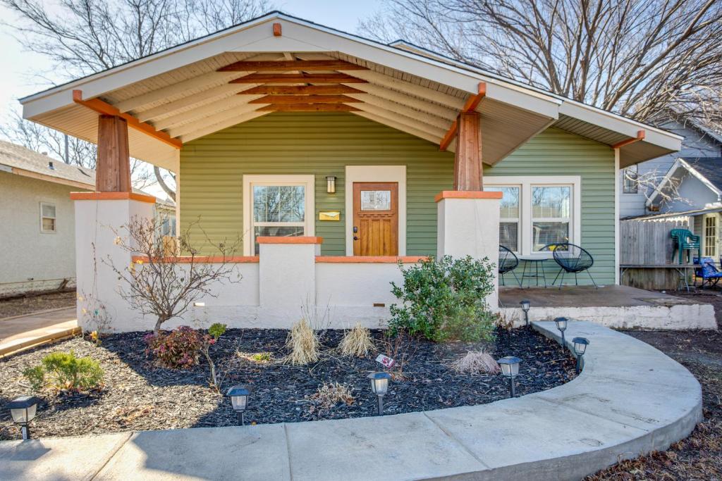 a small green house with a porch at Chic Lawton Home, 5 Mins to Fort Sill! in Lawton