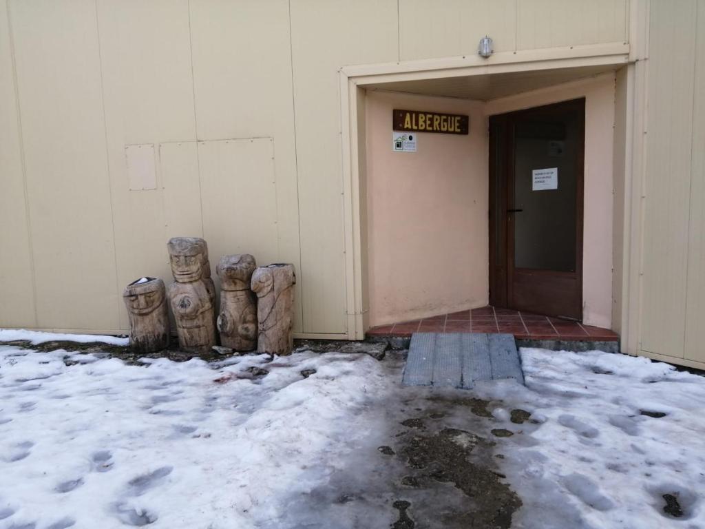 an entrance to a building with snow on the ground at Albergue La Pinilla in Madrid