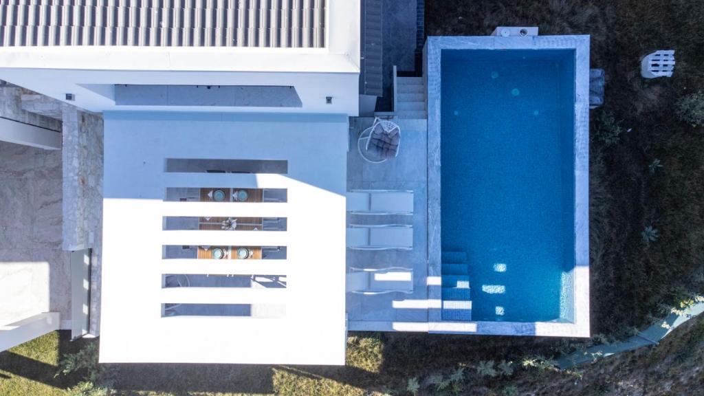 an overhead view of a building with a swimming pool at Panoramic Villa #1 in Hanioti