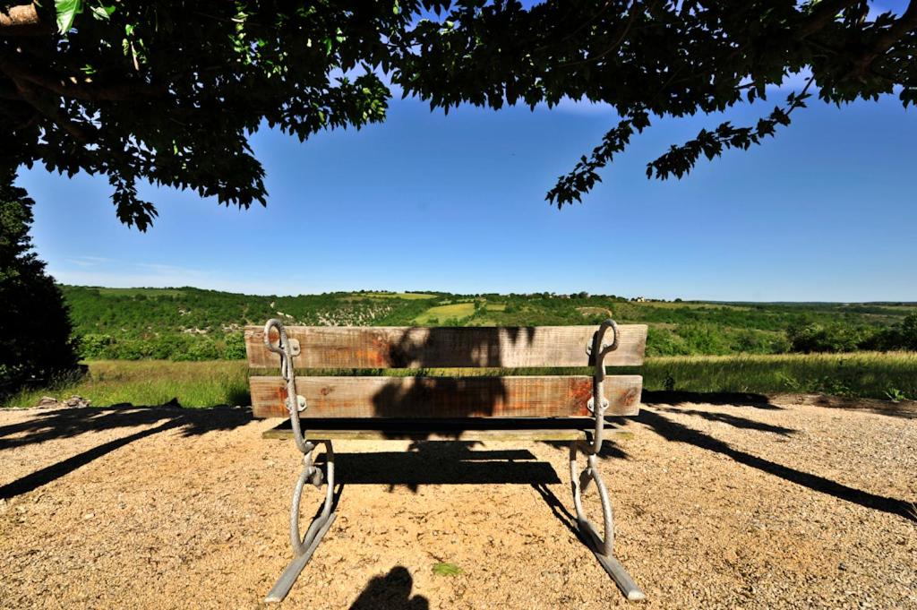 a bench sitting in the dirt under a tree at Domaine Lagardelle Rocamadour in Rocamadour