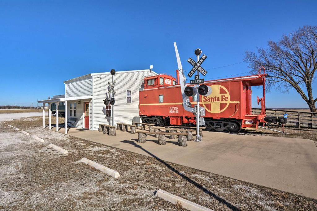 a train car parked next to a train station at Unique Joplin Gem Converted Train Car Studio in Joplin
