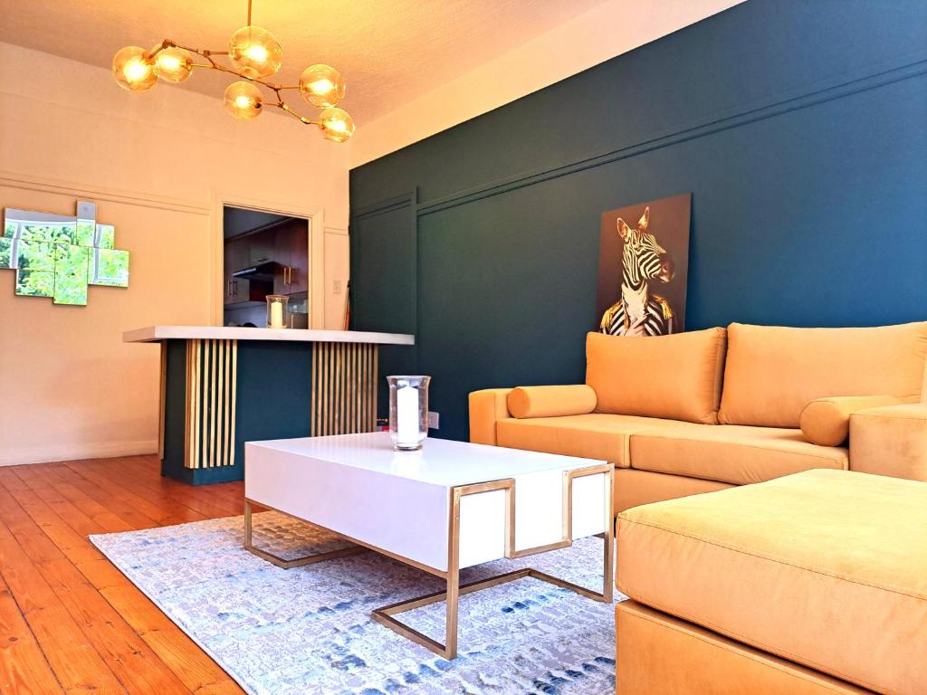 a living room with a couch and a coffee table at Secure Modern 2 bed - excellently located in Cape Town