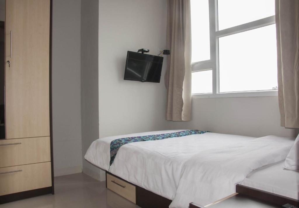 Postel nebo postele na pokoji v ubytování Skyland City Hotel Jatinangor