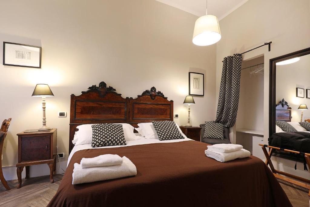 a bedroom with a large bed with two towels on it at Residenza Mazzini in Rome