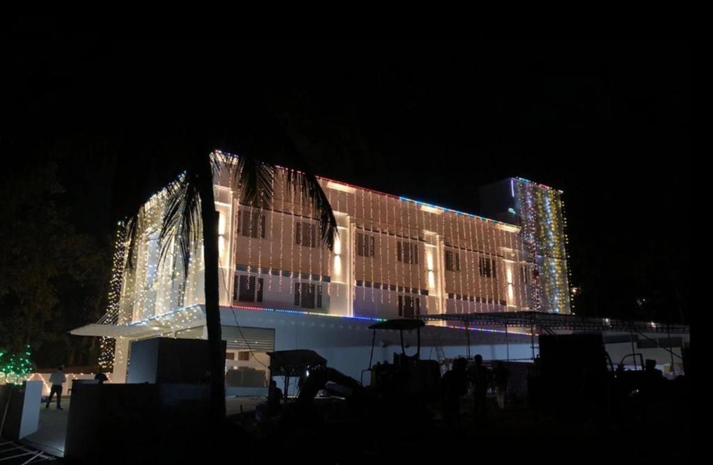 um edifício com luzes de Natal à noite em Bhagavath Residency em Pathanāmthitta