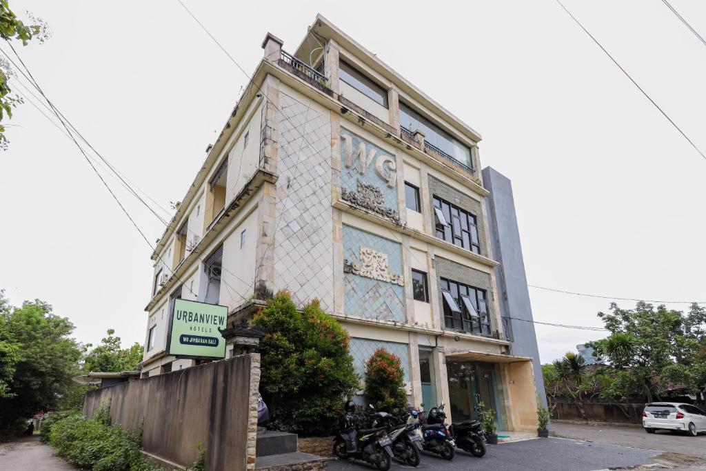 a building with motorcycles parked in front of it at Urbanview Hotel WG Jimbaran Bali in Ungasan