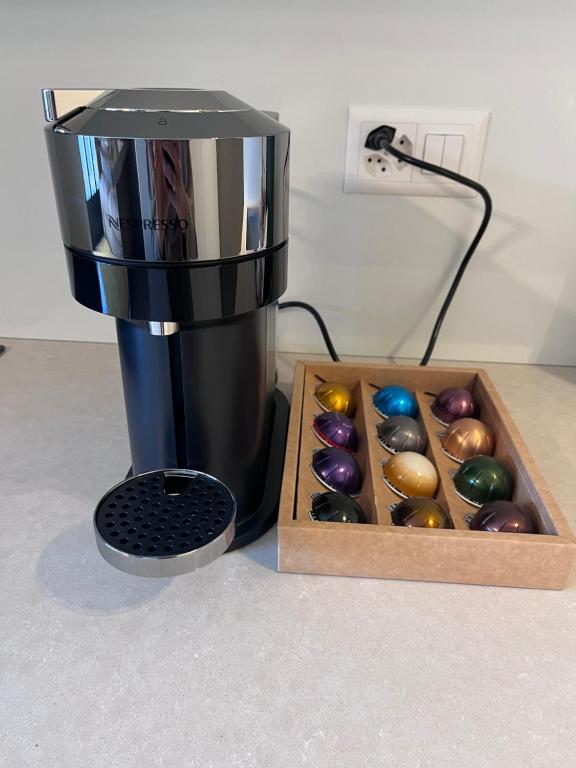 a coffee maker sitting next to a box of chocolates at Riva 14 in Lugano