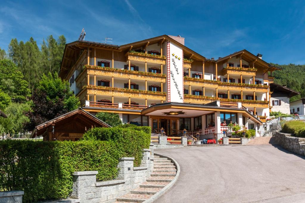 a large building with a road in front of it at Hotel Bellavista in Pinzolo