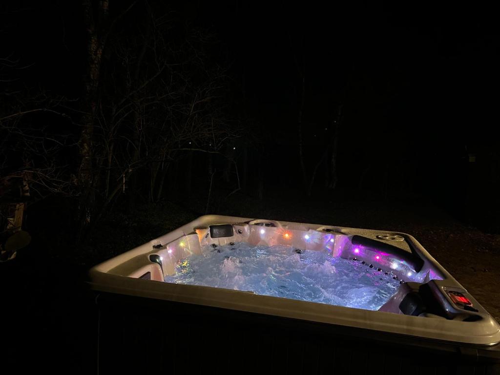 a hot tub with lights in the dark at The Cottage in Bocholt